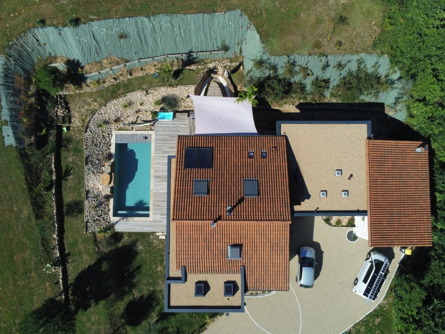 Maison, toiture et terrasse de piscine vues du ciel